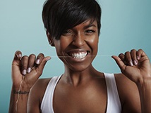 Woman who is smiling while flossing