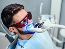 : a person receiving in-office teeth whitening