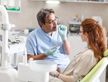 Dentist talking to patient