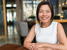 Younger woman in café who is smiling