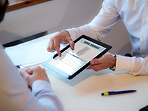 Patient reviewing dental insurance forms on tablet