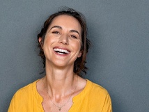 Woman smiling in yellow shirt