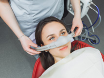 Woman wearing a nasal mask at the dentist’s office 