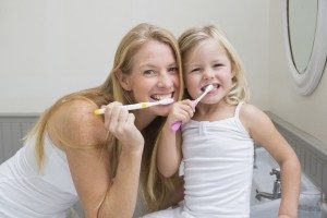 mother and daughter brushing teeth