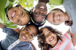 children smiling at family dentist in Springfield