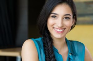 Woman smiling after visiting her dentist in Springfield