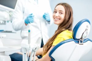 Woman smiling during visit with dentist in Springfield