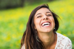 Woman using benefits of smiling while standing outside