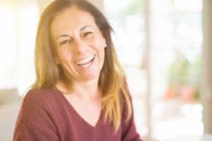 Older woman smiling with dental implants