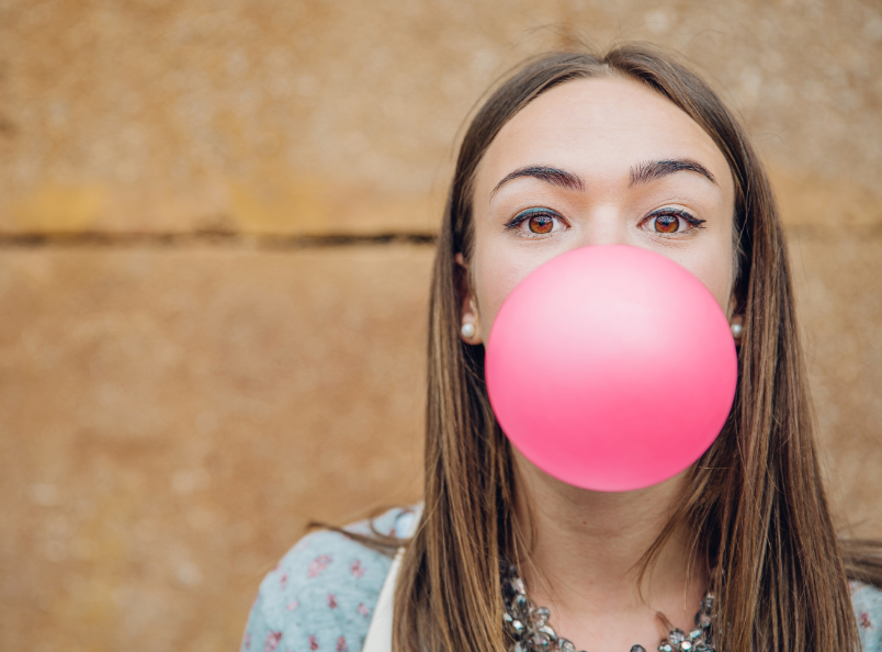 Woman blowing bubble gum bubble